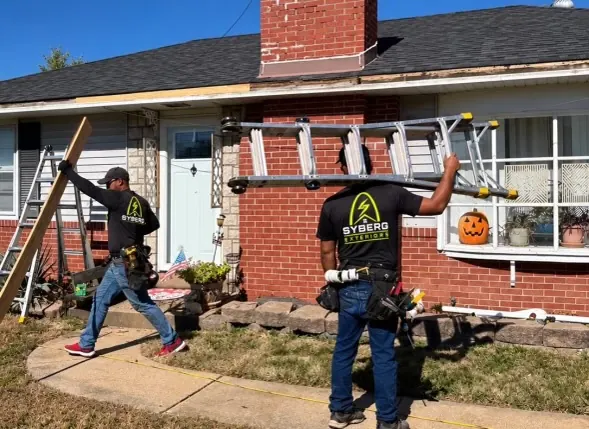 Installers moving roofline materials into position
