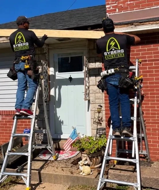 Crew working from ladders on the gutter line